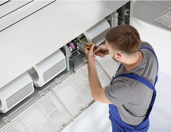 Worker Repairing Aircon — Commercial HVAC Cleaners in South East Queensland