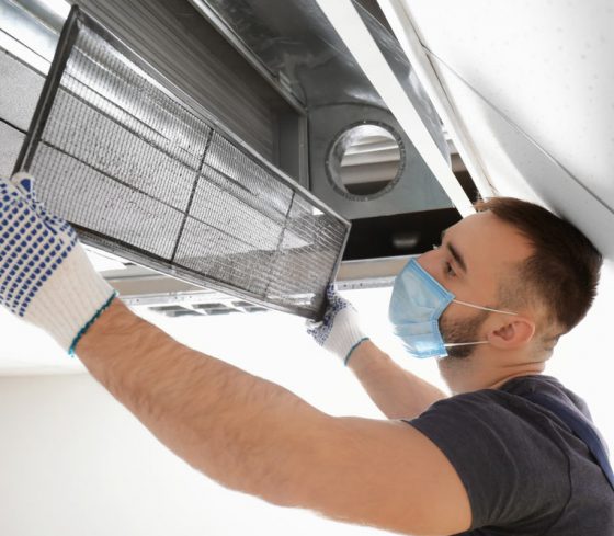 Man Cleaning Industrial Air Conditioner